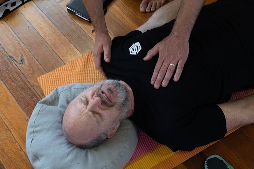 One of the participants laying down doing breathwork