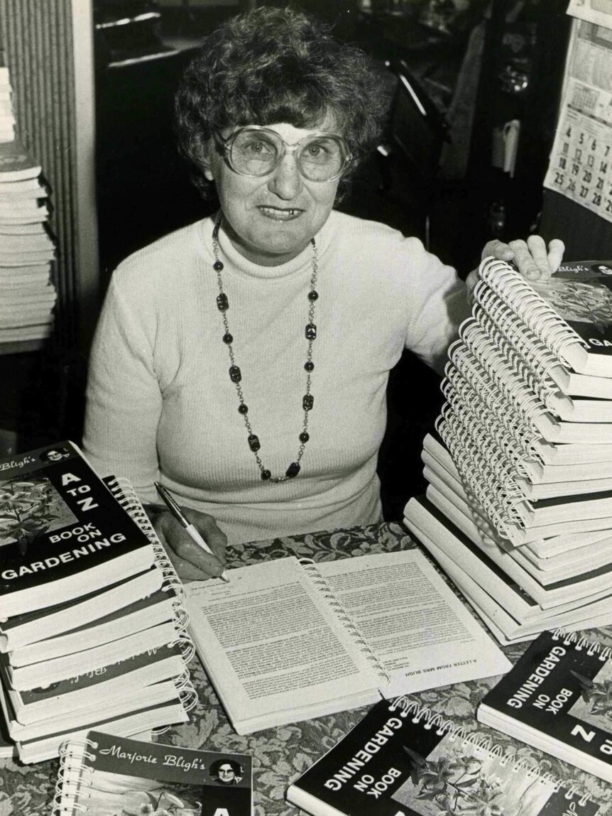 Marjorie Bligh signing books in 1982 before they were boxed up for delivery by coach.