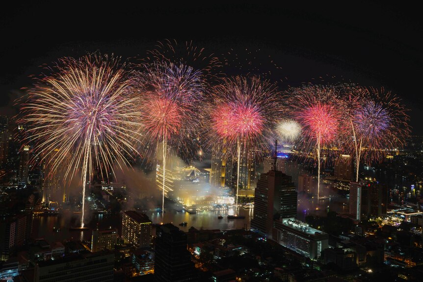 Fireworks explode over the Chao Phraya River during New Year celebrations in Bangkok.