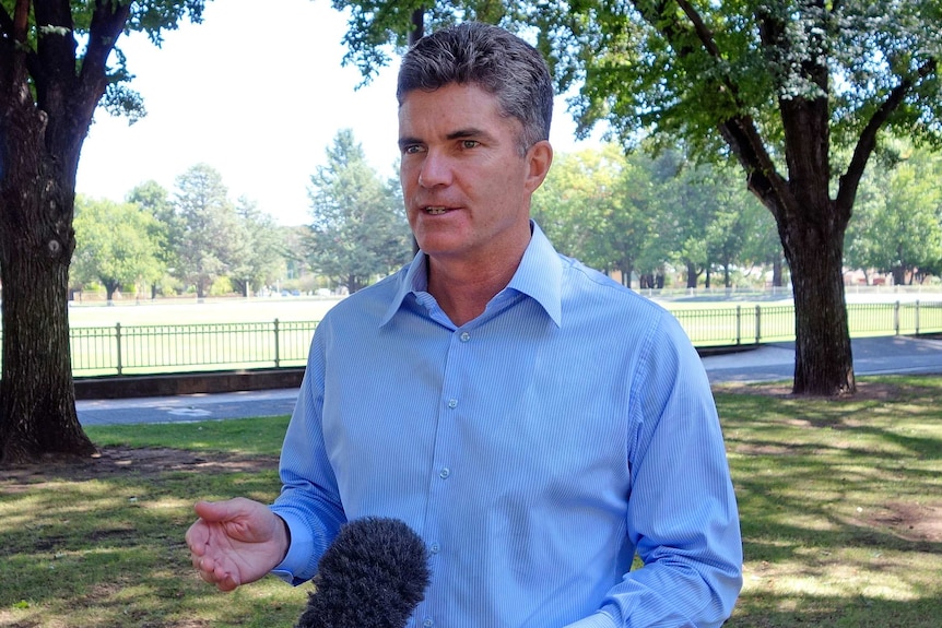 a man speaking in to a mic