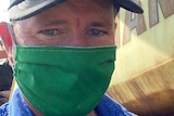 Grain Growers chairman Brett Hosking standing next to a truck wearing a face mask.