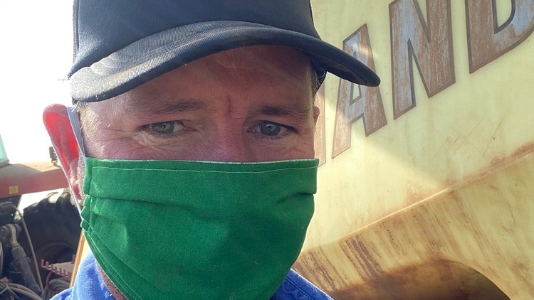 Grain Growers chairman Brett Hosking standing next to a truck wearing a face mask.