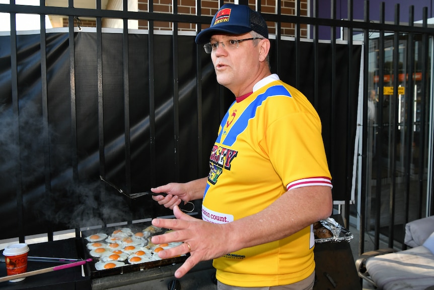 Prime Minister Scott Morrison helps cook breakfast for students.