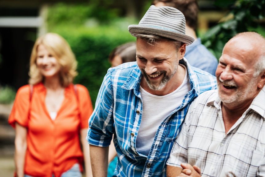 Young man with older man smiling