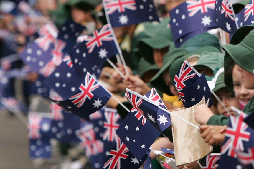 Kids wave Australian flags