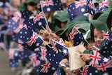 Kids wave Australian flags