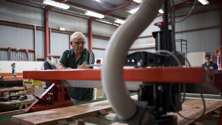 Kambalda men's shed treasurer Jim Hollis works on a project using the new wood machine.