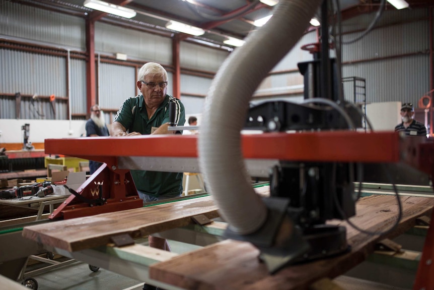 Kambalda men's shed treasurer Jim Hollis works on a project using the new wood machine.