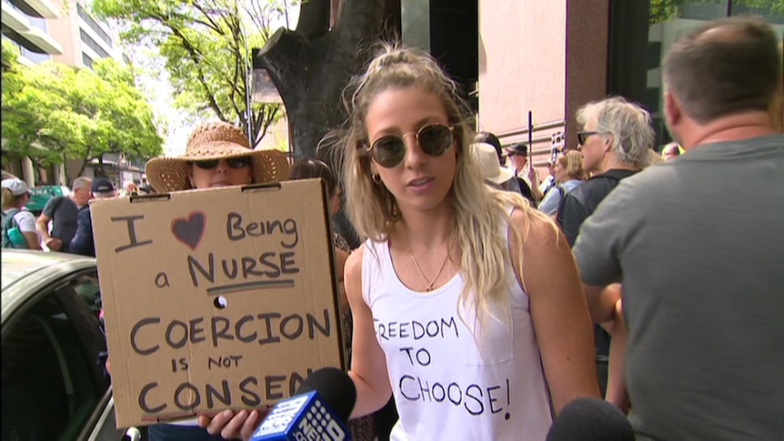 A woman holding a sign