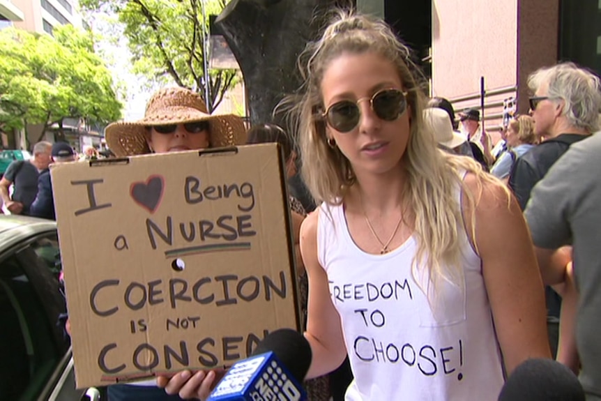 A woman holding a sign