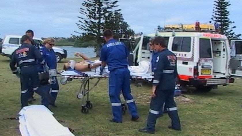 Paramedics treat shark attack victim John Beard.