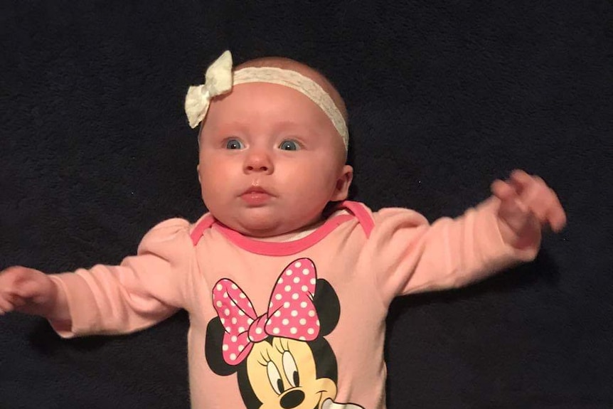Baby Darcey in Minnie Mouse outfit.