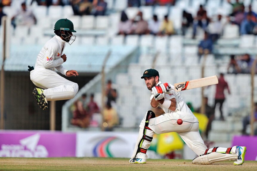 Australia's Glenn Maxwell sweeps hard against Bangladesh