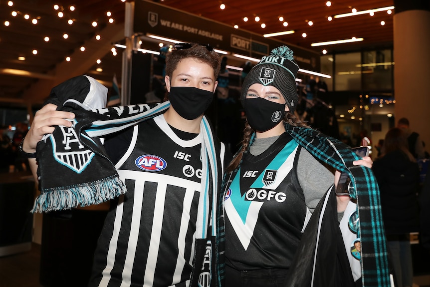 Port Adelaide Power fans pose in the traditional black and white guernsey