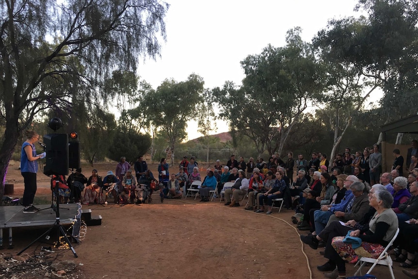 People sit outdoors at the opening of the NT Writers Festival in Alice Springs