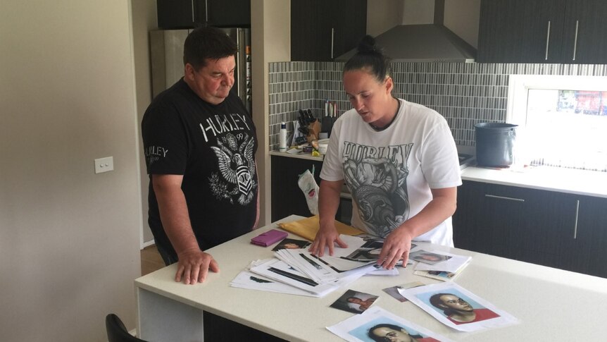 Corinna Horvath and Craig Love look over the documentation of Corinna's 1996 injuries.