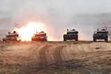 Four British Army Challenger 2 tanks fire during exercise.