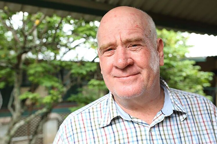 A head and shoulders shot of Christmas Island Shire President Gordon Thomson smiling for a photo.