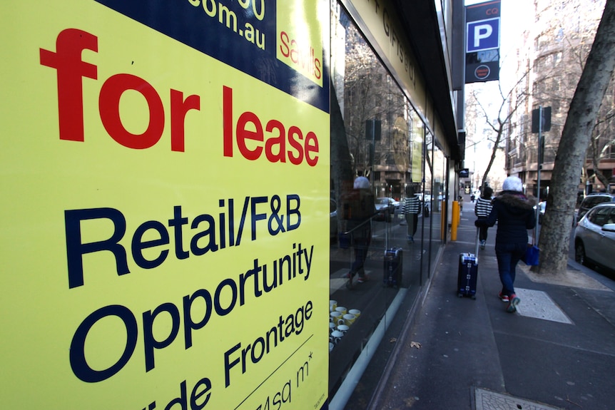 A for lease sign on a city street, advertising office office space.