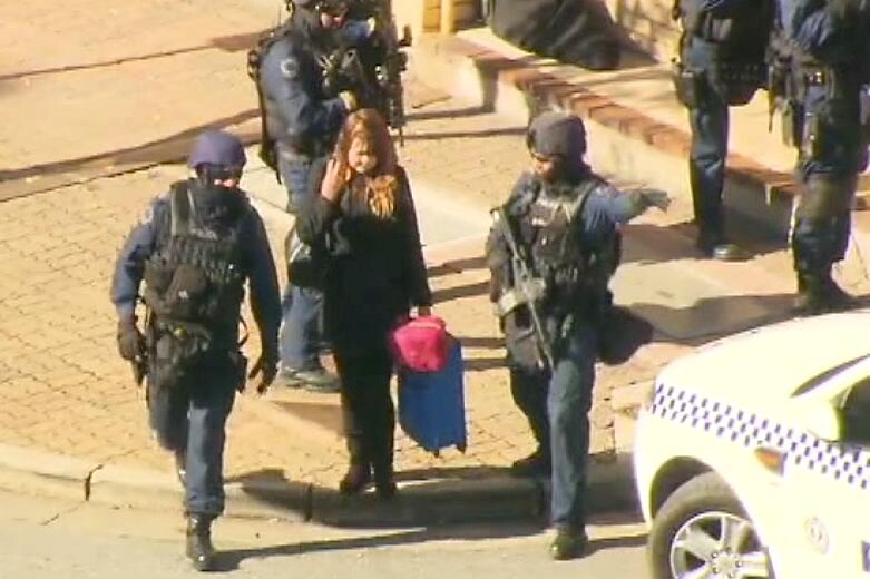 A hostage is removed from the scene of a siege where Rodney Ian Clavell is holed up.