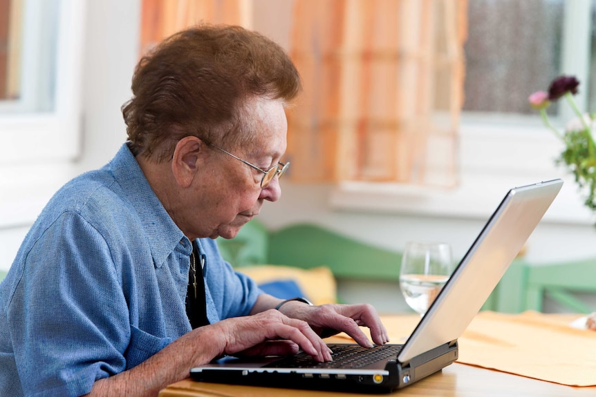 An older woman using a computer.