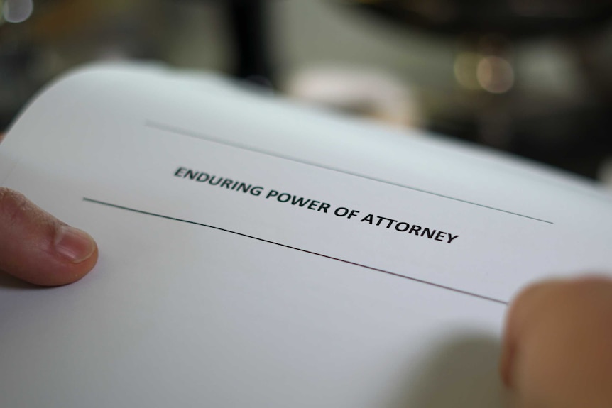 A close-up picture of an enduring power of attorney form being held by someone