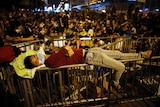 A pro-democracy protester sleeps over a barricade at the Mong Kok shopping district of Hong Kong October 20, 2014.