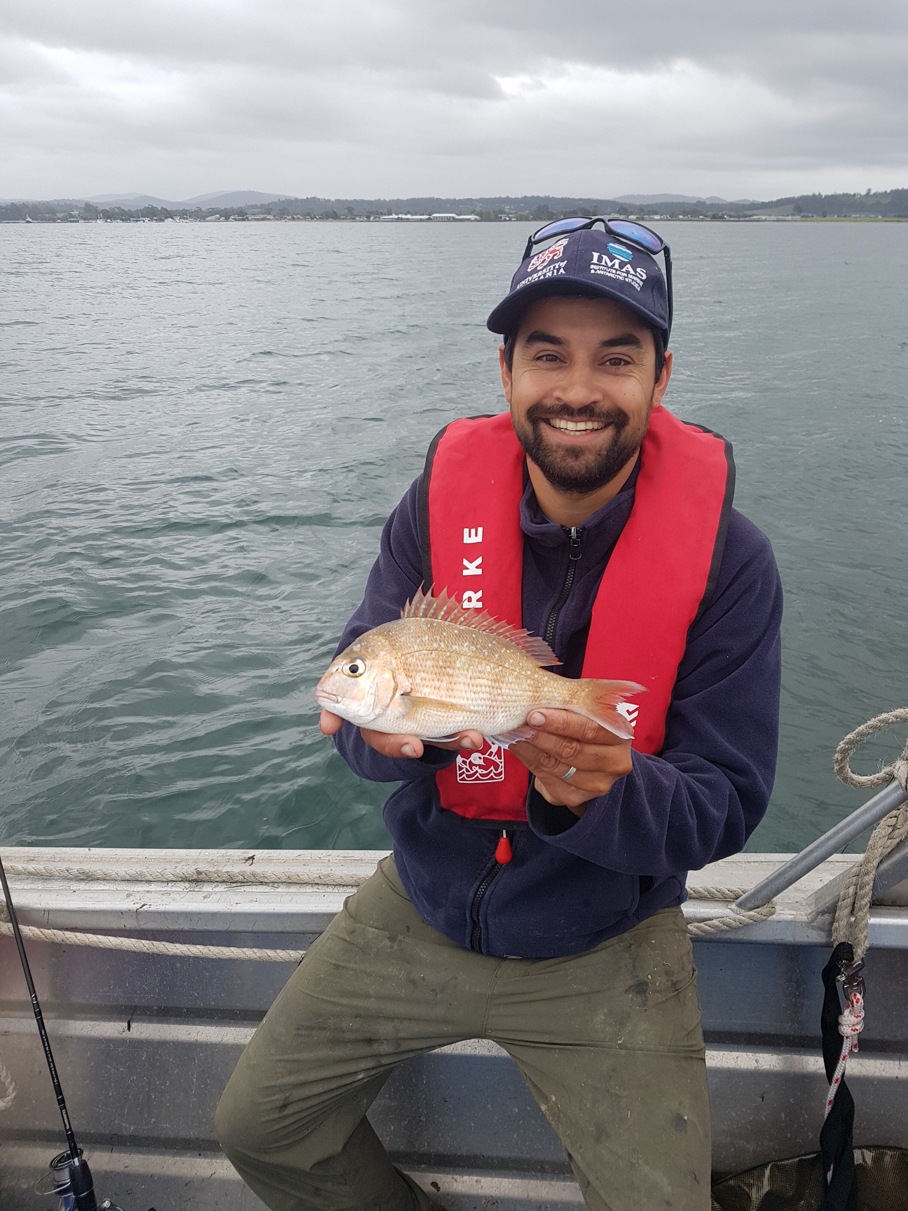 man holding small fish