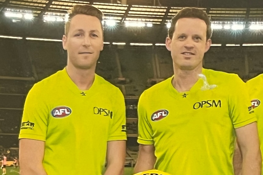 An old photo of Brett Rosebury and Shane McInerney standing side-by-side in umpire uniforms.