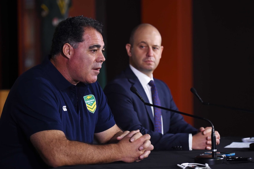 A rugby league coach sits alongside an administrator at a media conference in Sydney.