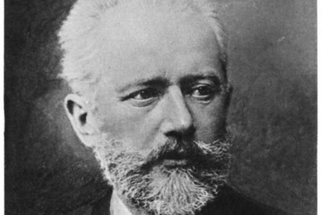 A black and white photo of a stern faced Pyotr Ilyich Tchaikovsky