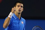 On top ... Novak Djokovic celebrates winning the first set
