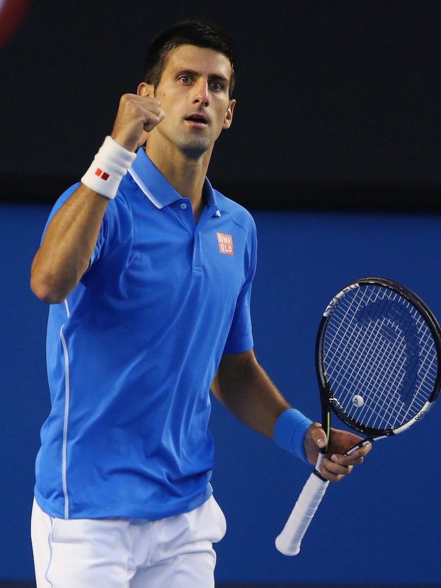 On top ... Novak Djokovic celebrates winning the first set