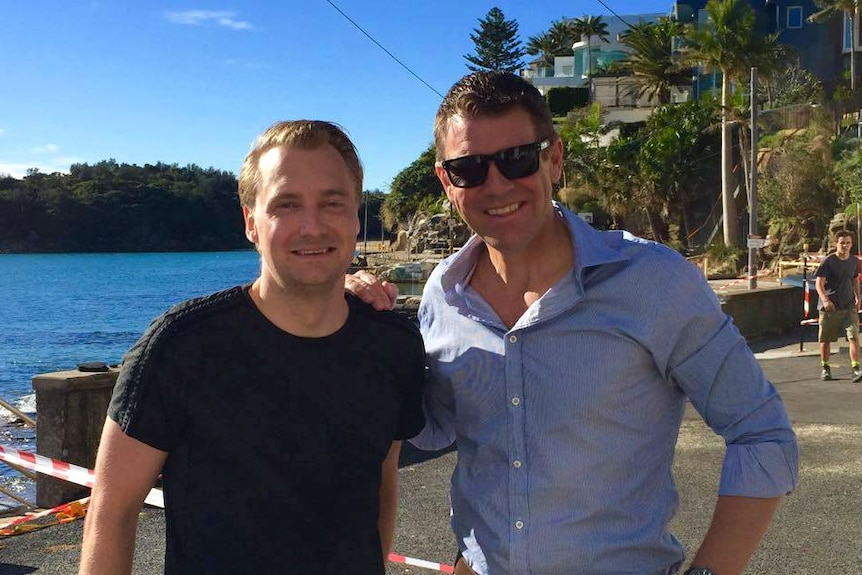 James Griffin and Mike Baird posing for a phot next to the water.