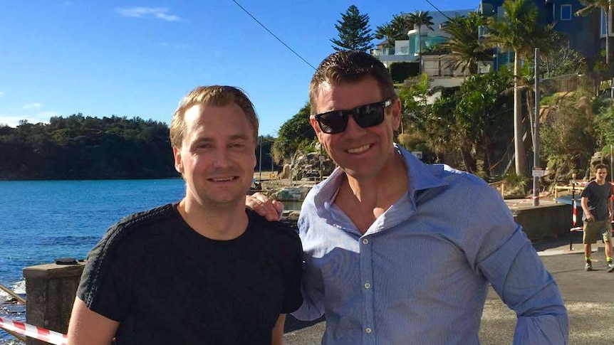 James Griffin and Mike Baird posing for a phot next to the water.