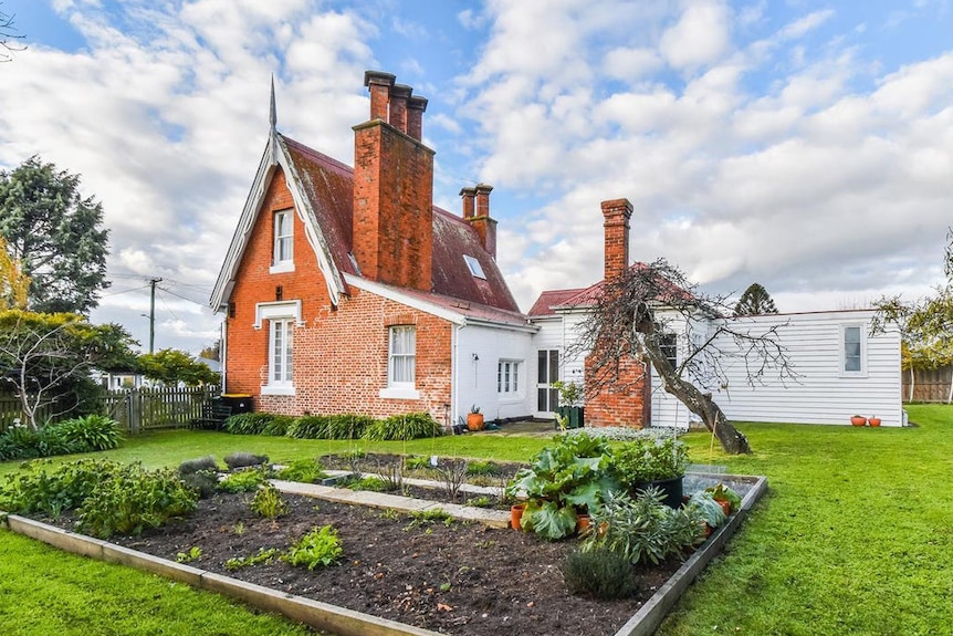 A red brick home and garden with vege patch.
