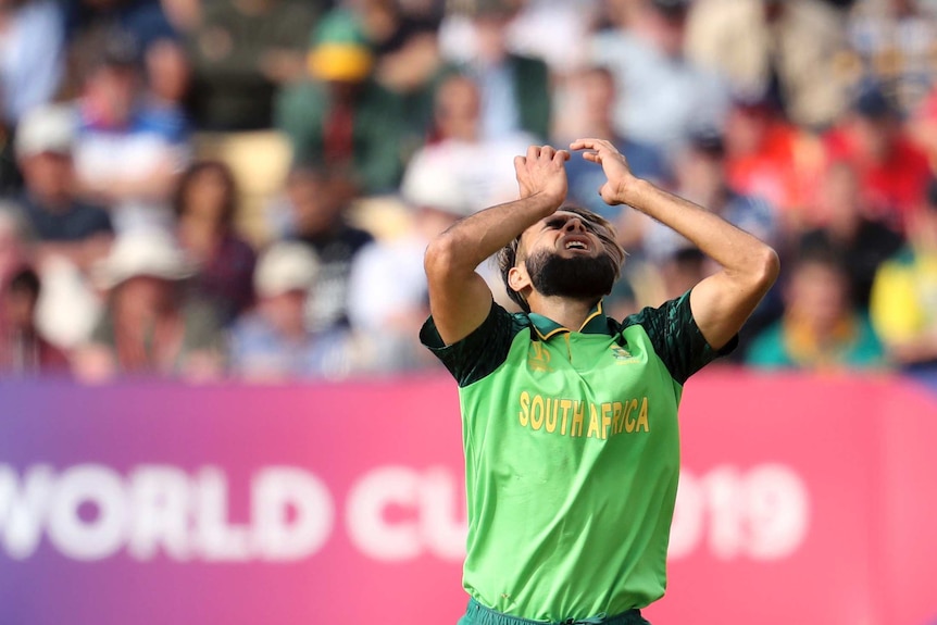 A bowler closes his eyes and throws hands in the air in frustration after failing to get a wicket.