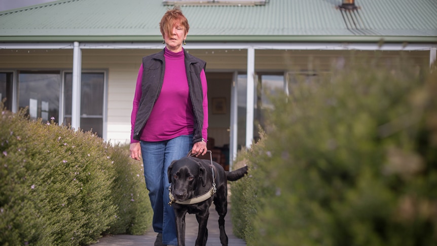 Faye and her guide dog Stony outside her house