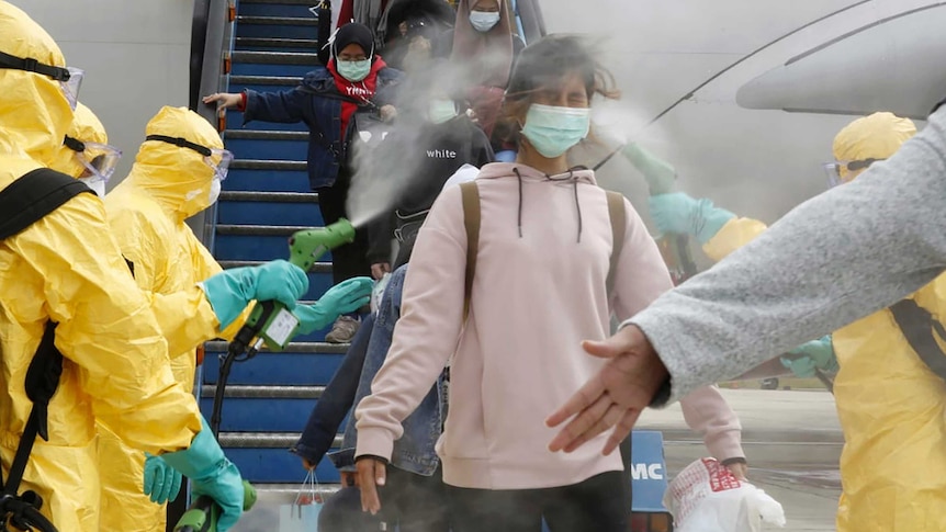 Indonesian nationals who arrived from Wuhan are sprayed with antiseptic on arrival.