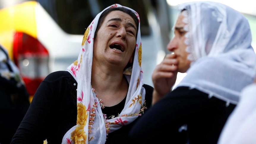 Mourners protest at Turkey funeral for wedding blast victims