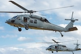 Two Sikorsky Seahawk helicopters in the sky during a NATO military exercise.