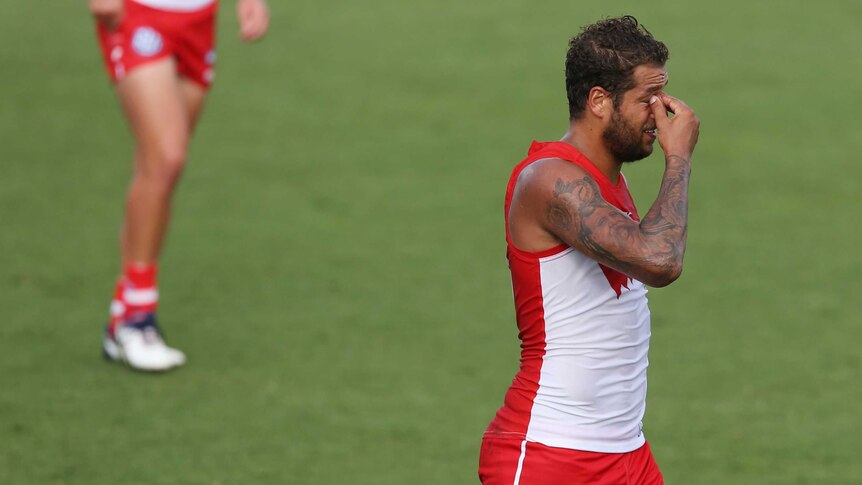 Swans return ... Lance Franklin leaves the field at the half-time break against the Power