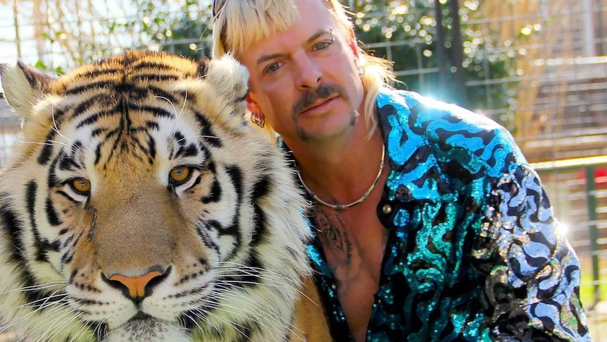 Joe Exotic from Netflix's Tiger King with a tiger for story on why it's popular during coronavirus isolation