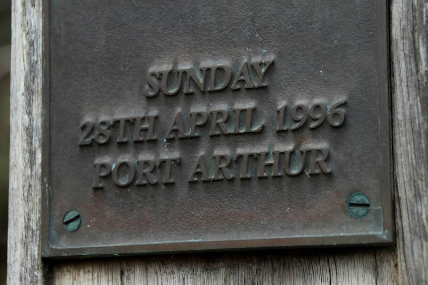 A brass plaque with writing 