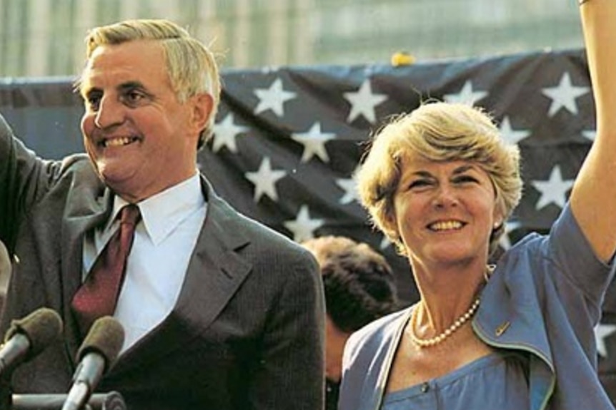 Walter Mondale and Geraldine Ferraro waving in front of an American flag