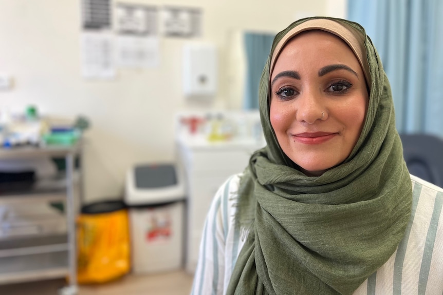 Umber Rind smiling in a headscarf in a medical centre