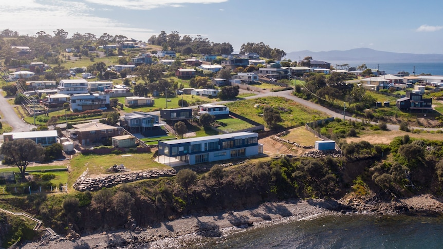 Houses seen from the air in a beachside suburb.