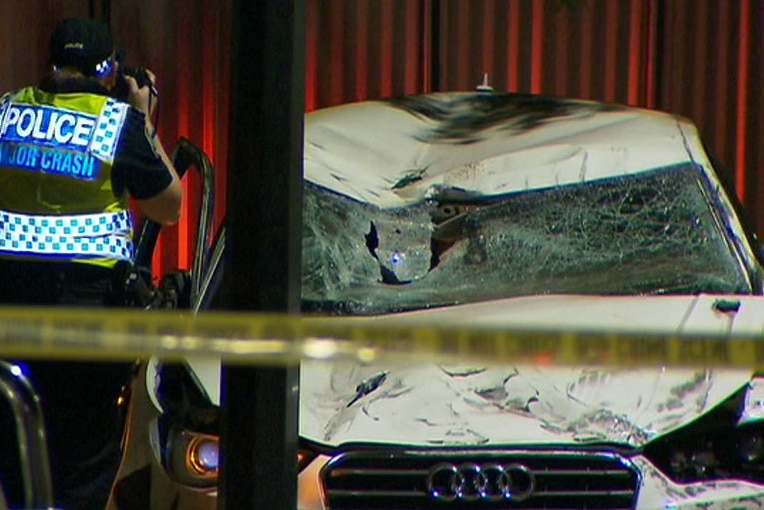 Police inspect the car in which Bor Mabil was killed.