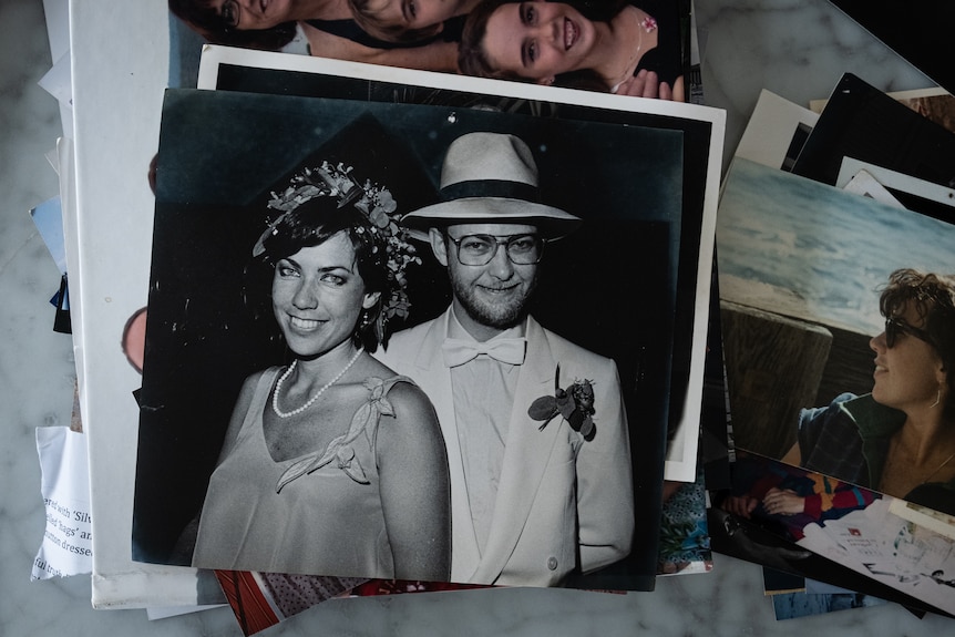 Black and white photo of a man nd woman. Man wears a fedora hat, both are smiling