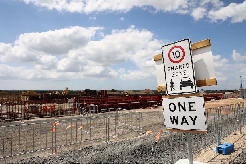 A construction site, with a sign that says "one way"